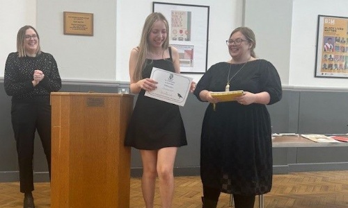 Awarding prizes during the poetry soirtee